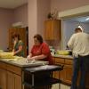 Kitchen crew cooking up the eggs & sausage.